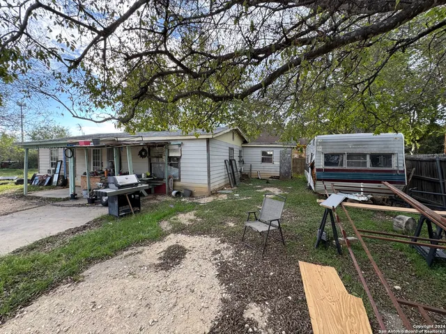 a view of a house with backyard porch and sitting area