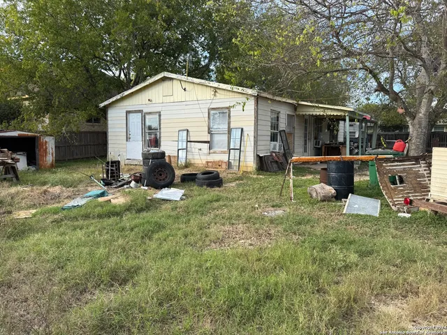a view of backyard of house with seating space