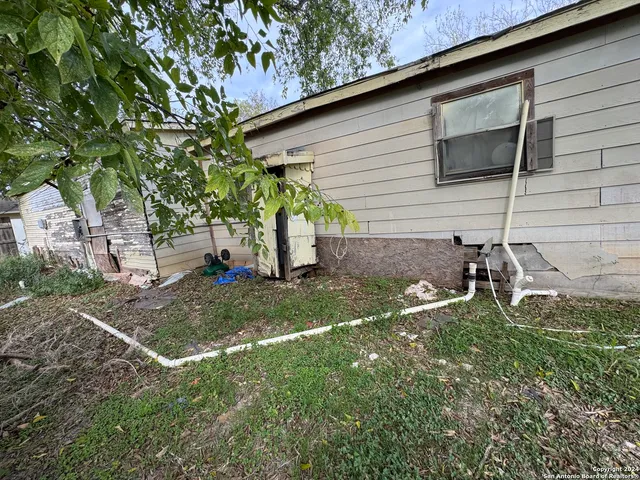 a backyard of a house with a tree