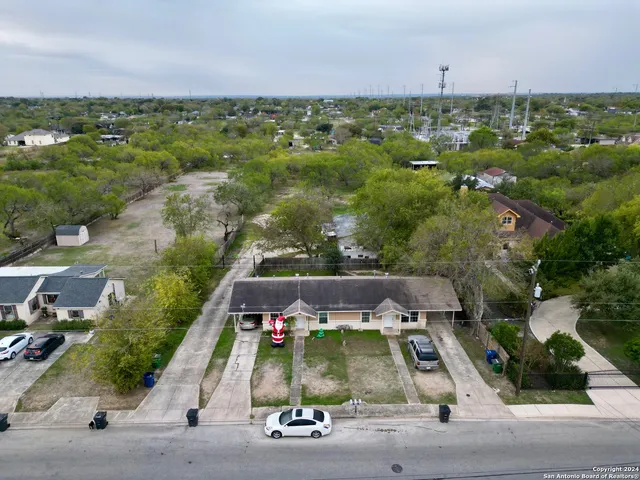 an aerial view of a house with a yard