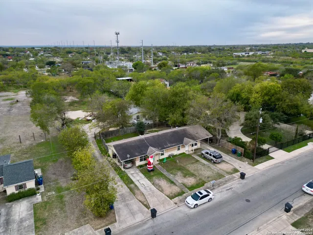 an aerial view of a residential houses with outdoor space