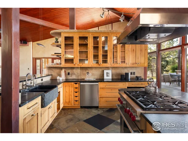 a kitchen with stainless steel appliances granite countertop a stove and a white cabinets