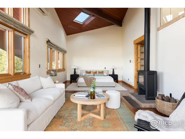 a living room with furniture a rug and a large window