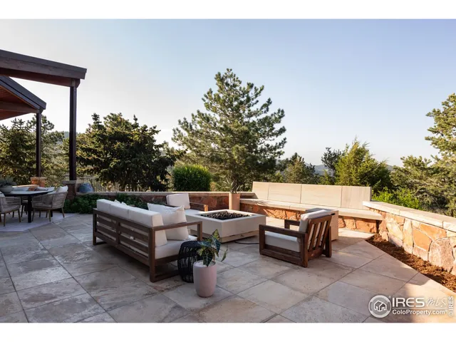 a backyard of a house with fire pit and outdoor seating