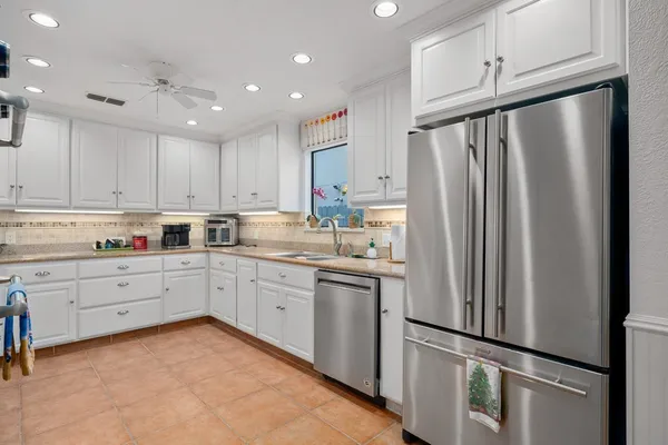a kitchen with granite countertop cabinets appliances and cabinets