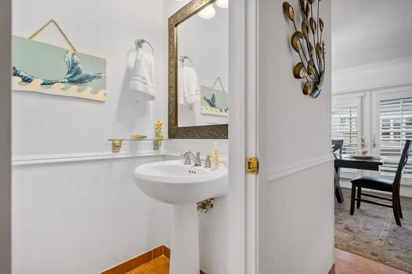 a bathroom with a sink a mirror and a window