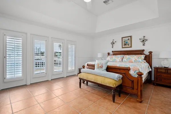 a spacious bedroom with a bed and a chair