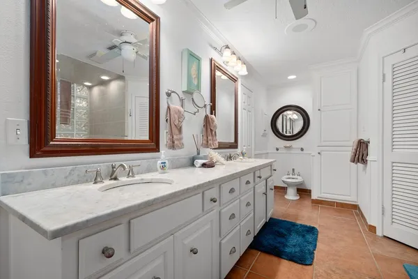 a bathroom with a sink vanity granite and a mirror