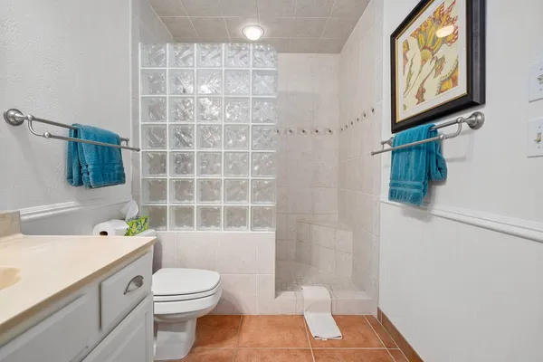 a bathroom with a toilet a sink and shower