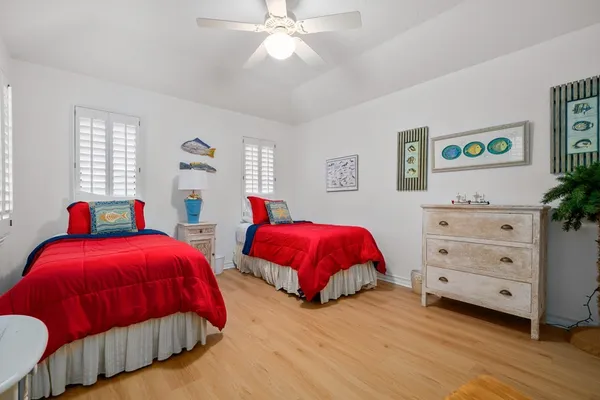 a bedroom with two beds and a window