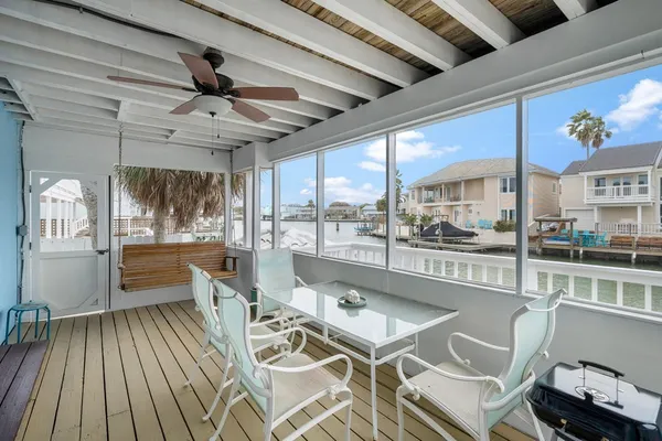 a dining hall with stainless steel appliances granite countertop a stove and cabinets with wooden floor