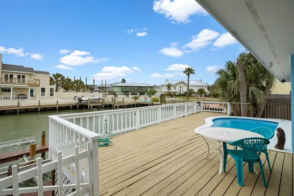 a view of a balcony with lake view and wooden floor