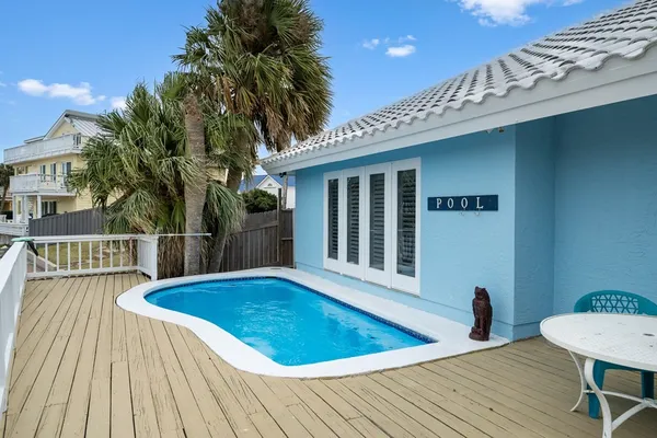 a view of a house with pool and sitting area