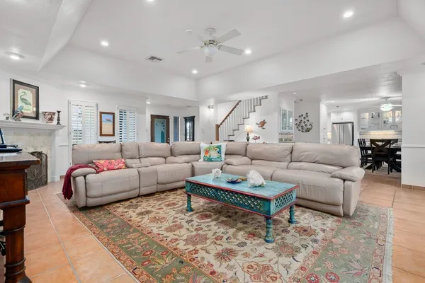 a living room with furniture and wooden floor