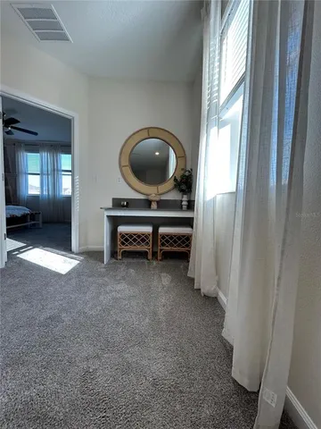 a bedroom with a bed next to a window