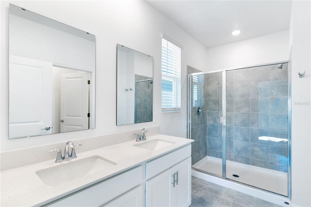 15524 Water Spring Boulevard Winter Garden, FL 34787 - Photo 36 of 40 a bathroom with a shower sink vanity and mirror