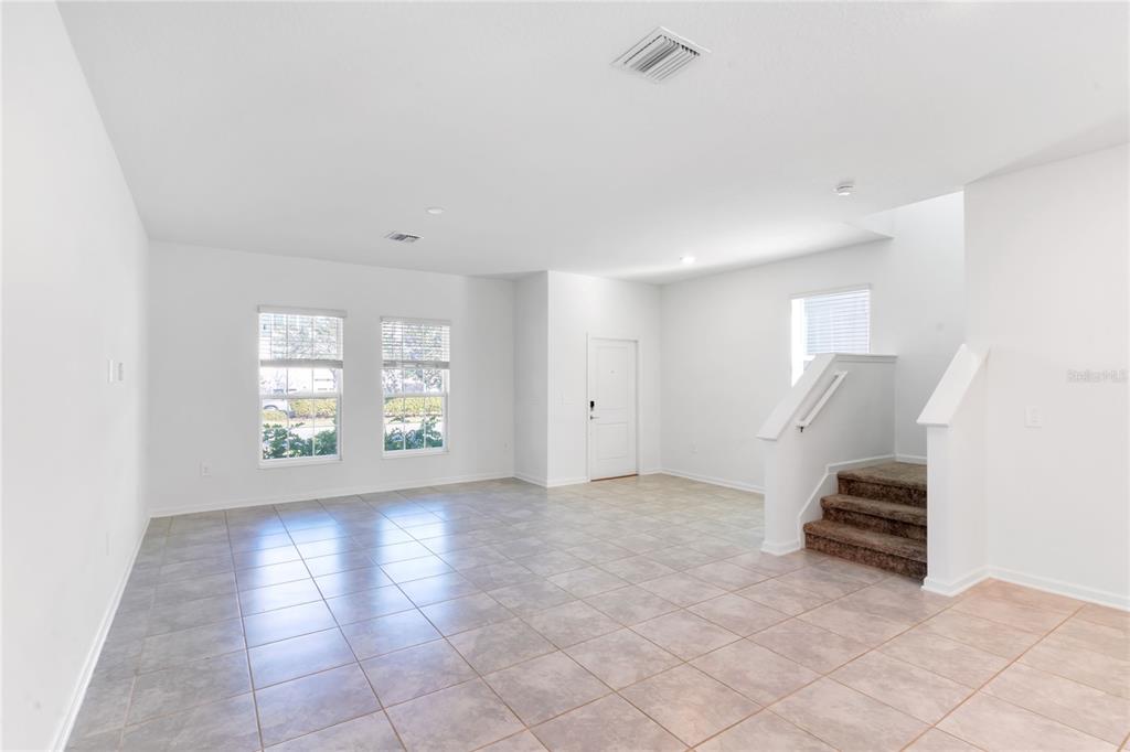 15524 Water Spring Boulevard Winter Garden, FL 34787 - Photo 6 of 40 a view of an empty room with stairs and a window