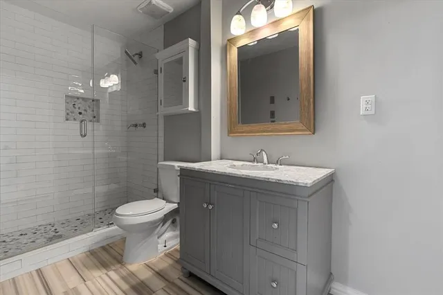 a bathroom with a sink toilet and shower
