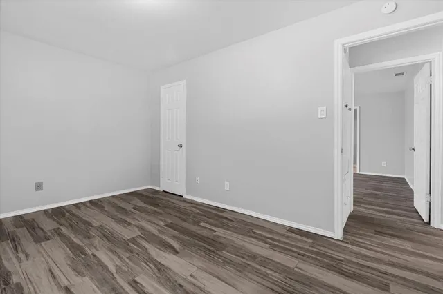 a view of room with wooden floor