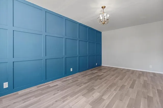 a view of a room with wooden floor and cabinet