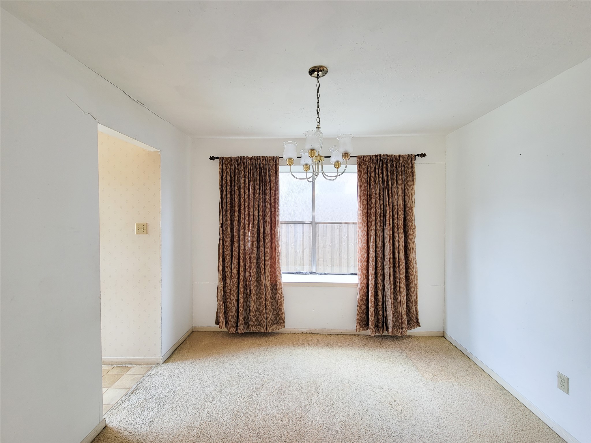23211 Timberbrook Drive Spring, TX 77373 - Photo 11 of 34 an empty room with chandelier fan and windows