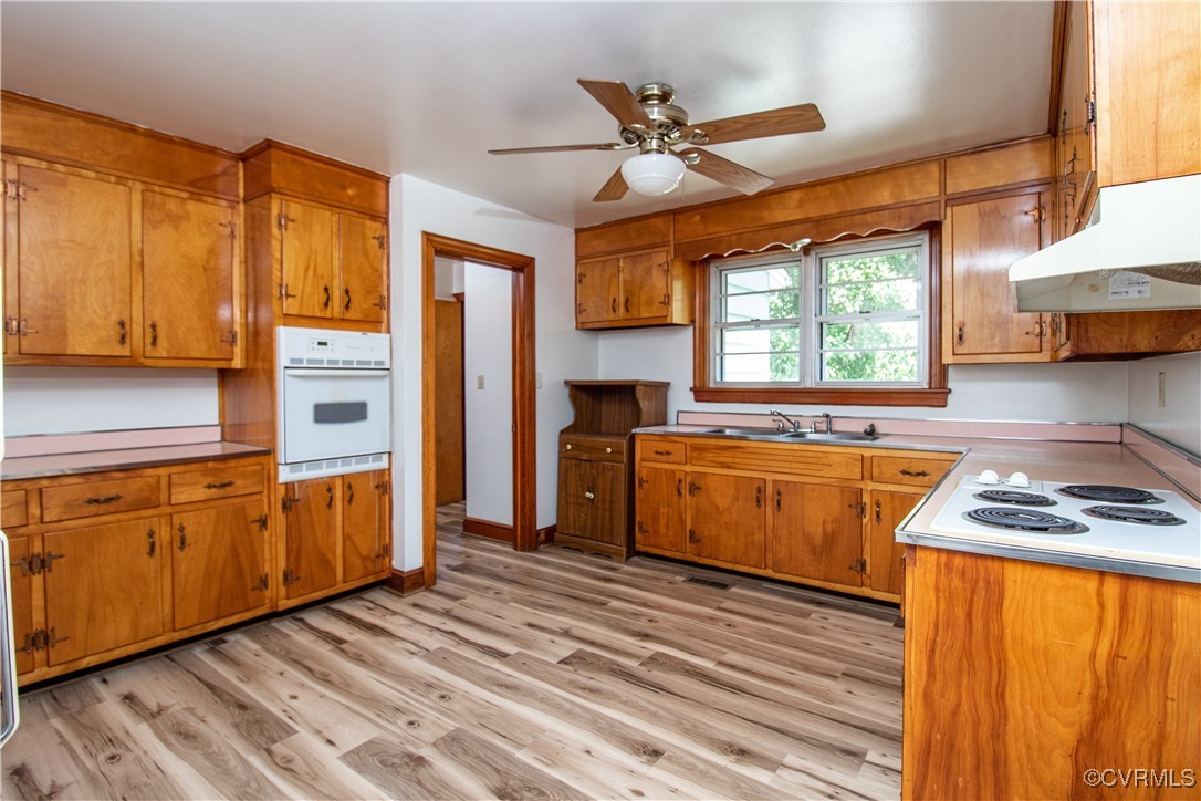 2400 East Hundred Road Chester, VA 23836 - Photo 11 of 27 a kitchen with stainless steel appliances granite countertop wooden cabinets a sink a stove a refrigerator with grey cabinets and wooden floor