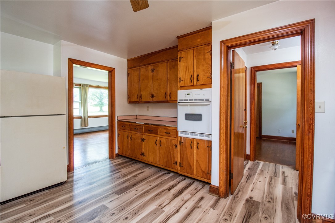 2400 East Hundred Road Chester, VA 23836 - Photo 14 of 27 a kitchen with stainless steel appliances granite countertop a refrigerator a stove and wooden floors