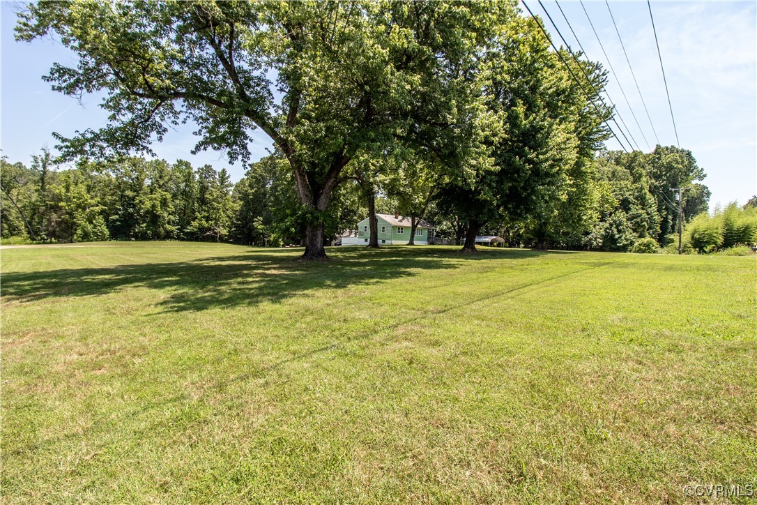 2400 East Hundred Road Chester, VA 23836 - Photo 21 of 27 a view of a swimming pool and trees in the background
