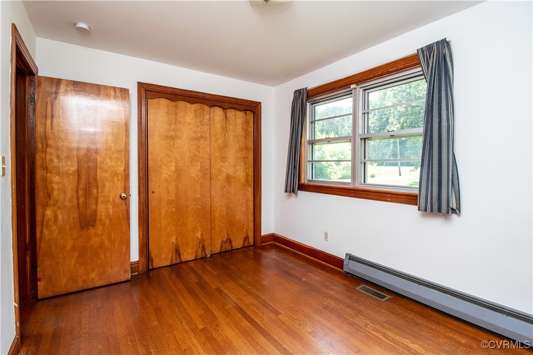2400 East Hundred Road Chester, VA 23836 - Photo 6 of 27 a view of an empty room with wooden floor and a window