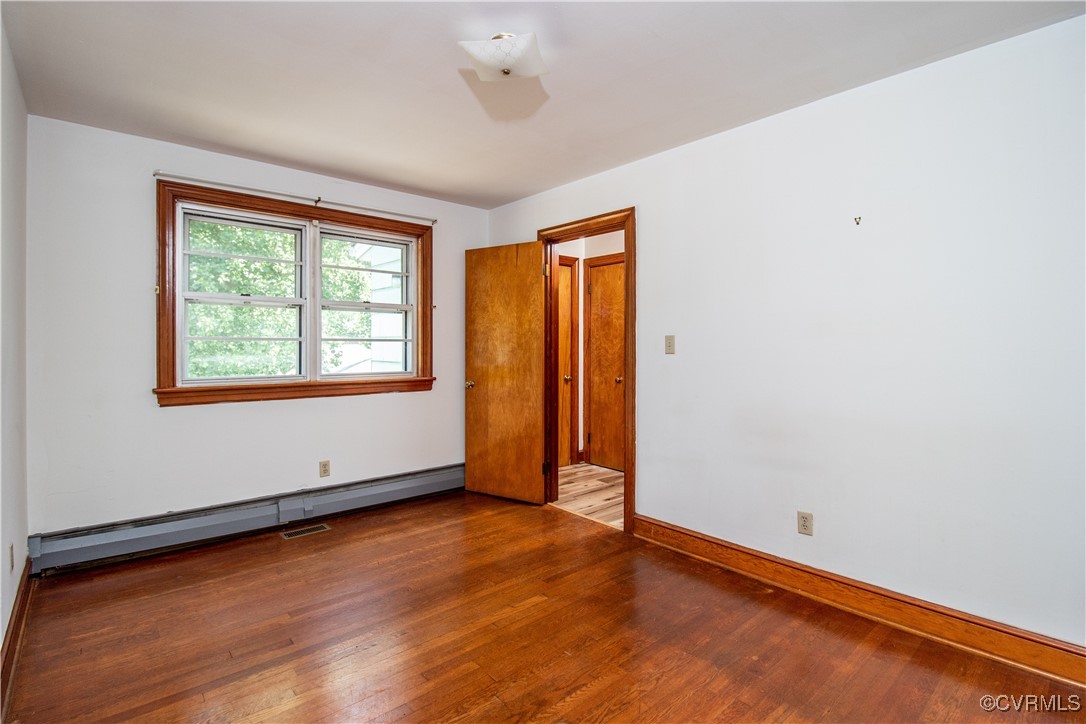 2400 East Hundred Road Chester, VA 23836 - Photo 9 of 27 an empty room with wooden floor and windows