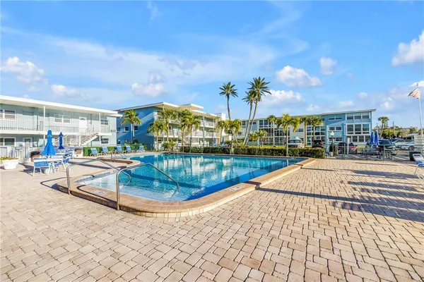 a view of a swimming pool with a lounge chairs