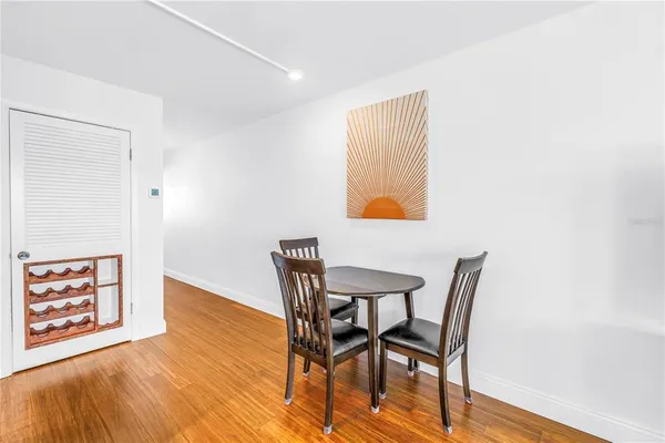 a view of a room with furniture and wooden floor