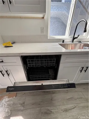 a kitchen with stainless steel appliances granite countertop a sink and cabinets