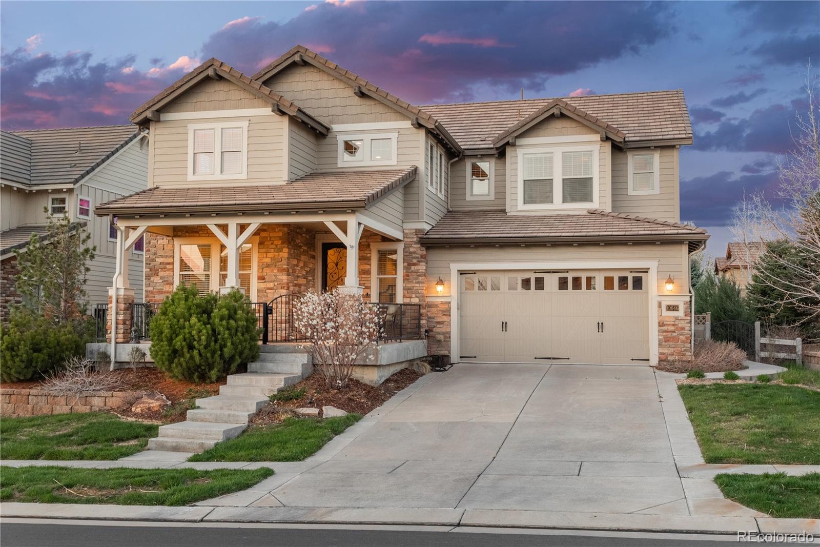 10646 Sundial Rim Road Highlands Ranch, CO 80126 - Photo 1 of 40 a view of white house with a yard and potted plants