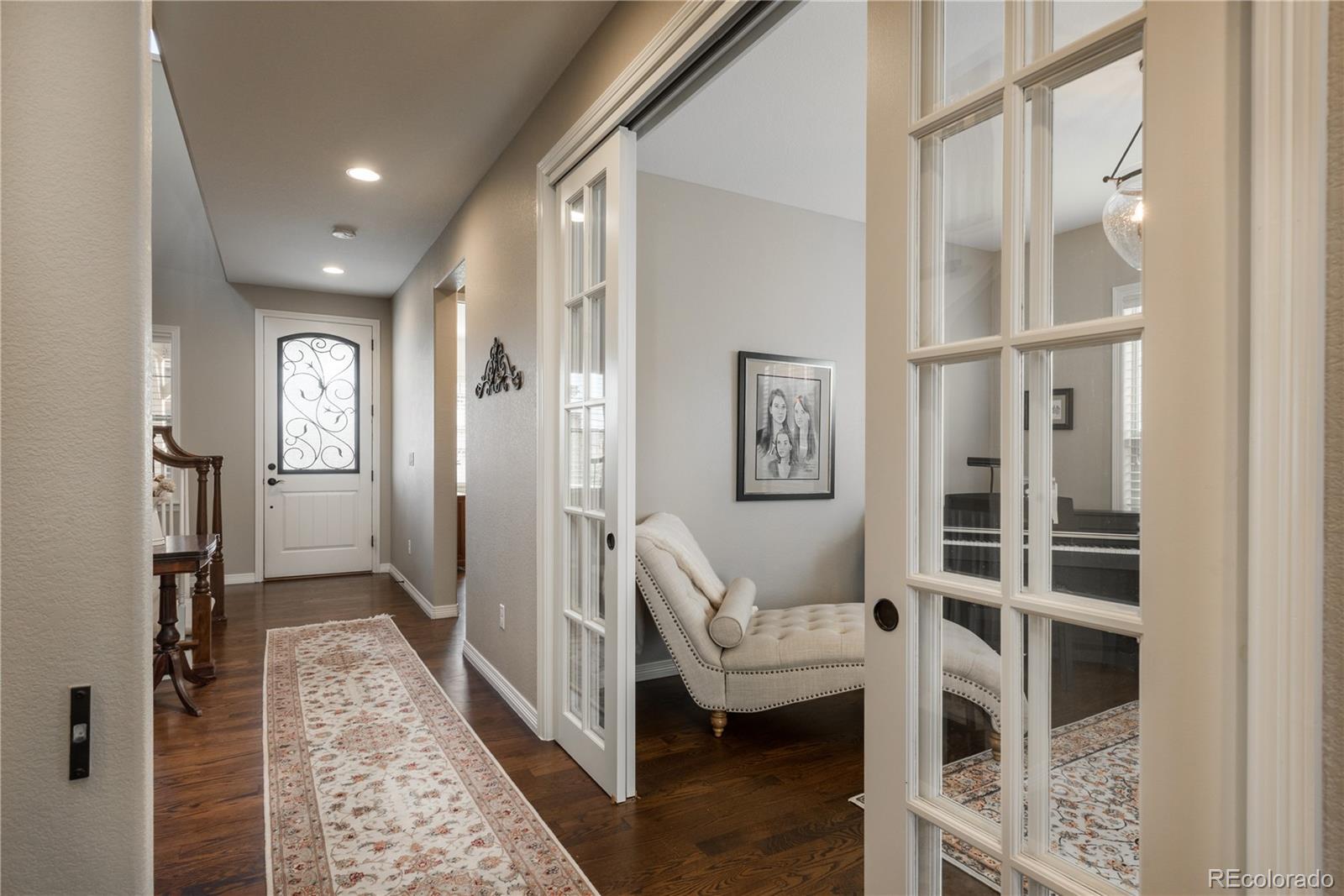 10646 Sundial Rim Road Highlands Ranch, CO 80126 - Photo 12 of 40 a view of entryway with furniture and wooden floor