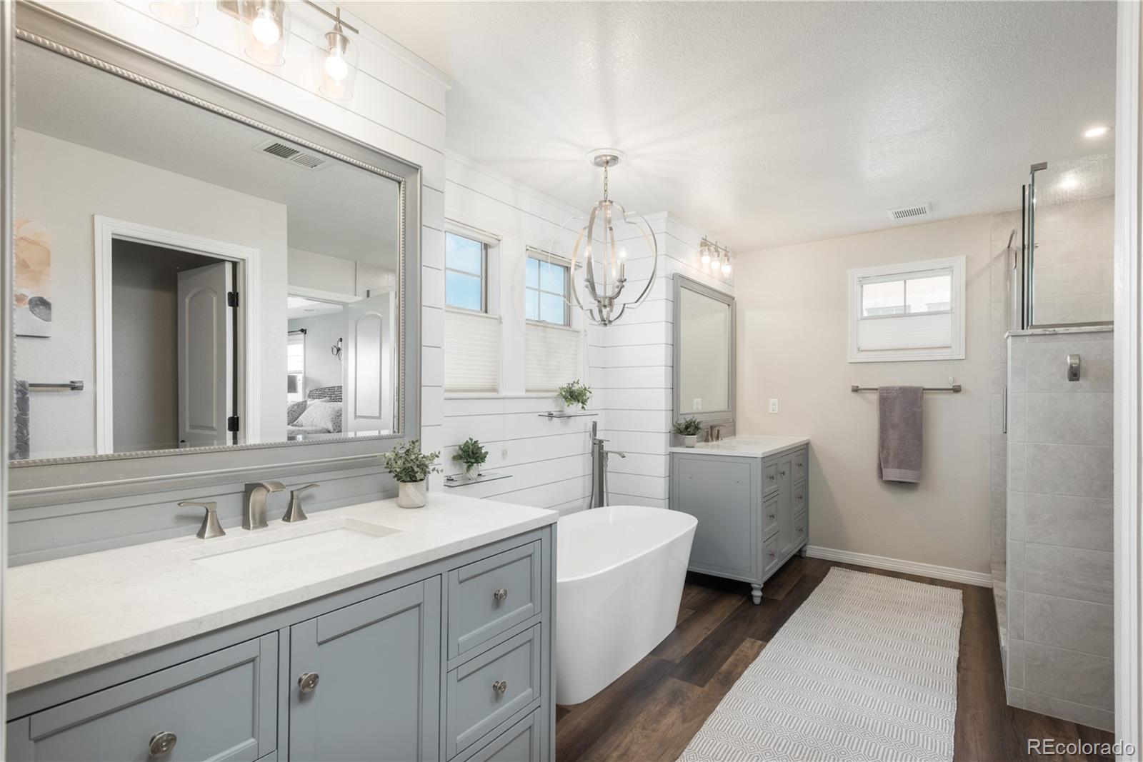 10646 Sundial Rim Road Highlands Ranch, CO 80126 - Photo 18 of 40 a bathroom with a sink a toilet and a large mirror