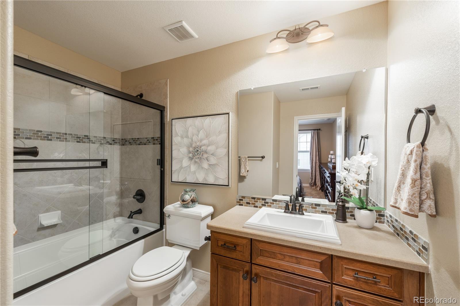 10646 Sundial Rim Road Highlands Ranch, CO 80126 - Photo 21 of 40 a bathroom with a sink a toilet and shower