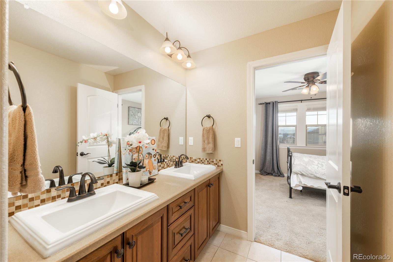 10646 Sundial Rim Road Highlands Ranch, CO 80126 - Photo 23 of 40 a bathroom with a double vanity sink mirror and