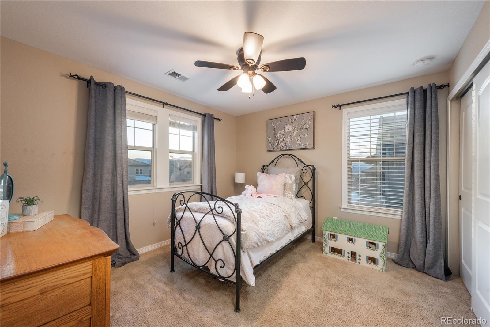 10646 Sundial Rim Road Highlands Ranch, CO 80126 - Photo 24 of 40 a bedroom with a bed and a window