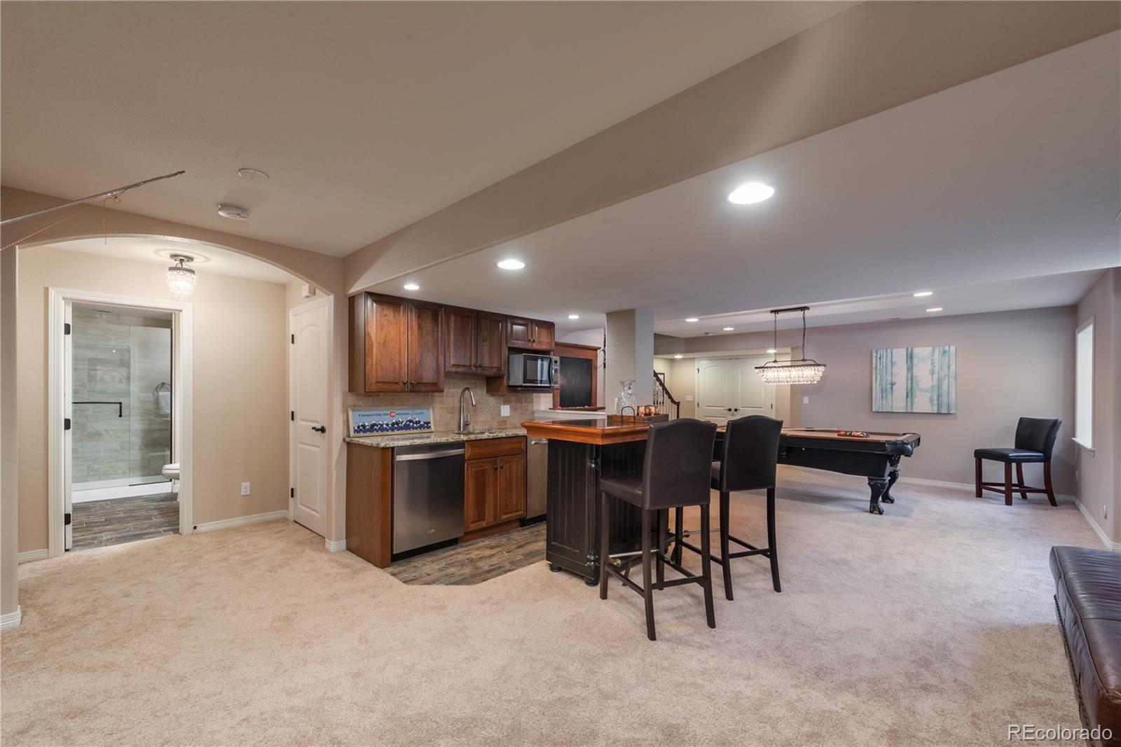 10646 Sundial Rim Road Highlands Ranch, CO 80126 - Photo 28 of 40 a kitchen with a table and chairs in it