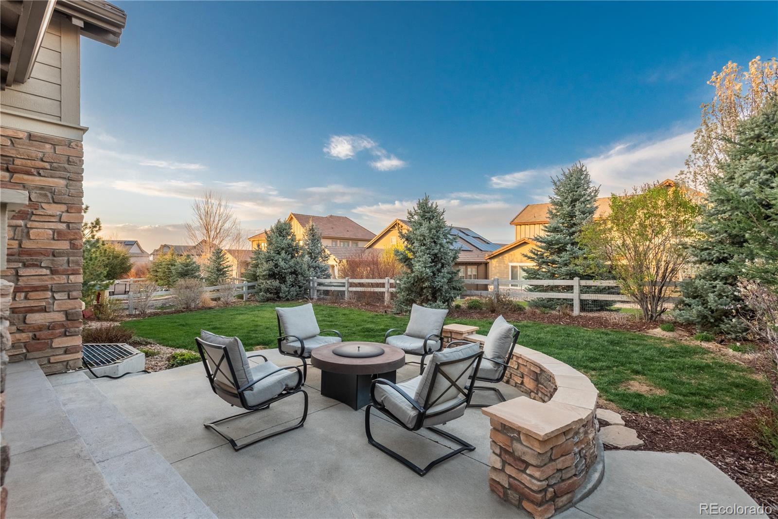 10646 Sundial Rim Road Highlands Ranch, CO 80126 - Photo 34 of 40 a view of a patio with couches chairs and a fire pit