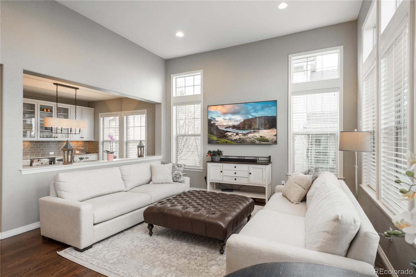 10646 Sundial Rim Road Highlands Ranch, CO 80126 - Photo 7 of 40 a living room with furniture and a flat screen tv