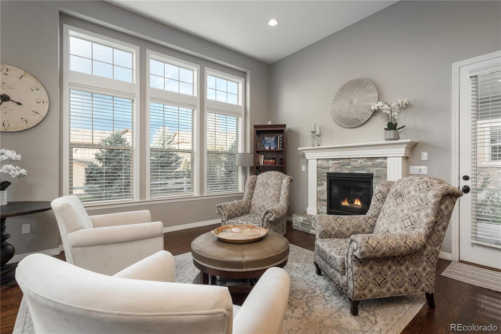 10646 Sundial Rim Road Highlands Ranch, CO 80126 - Photo 9 of 40 a living room with furniture a large window and a fireplace