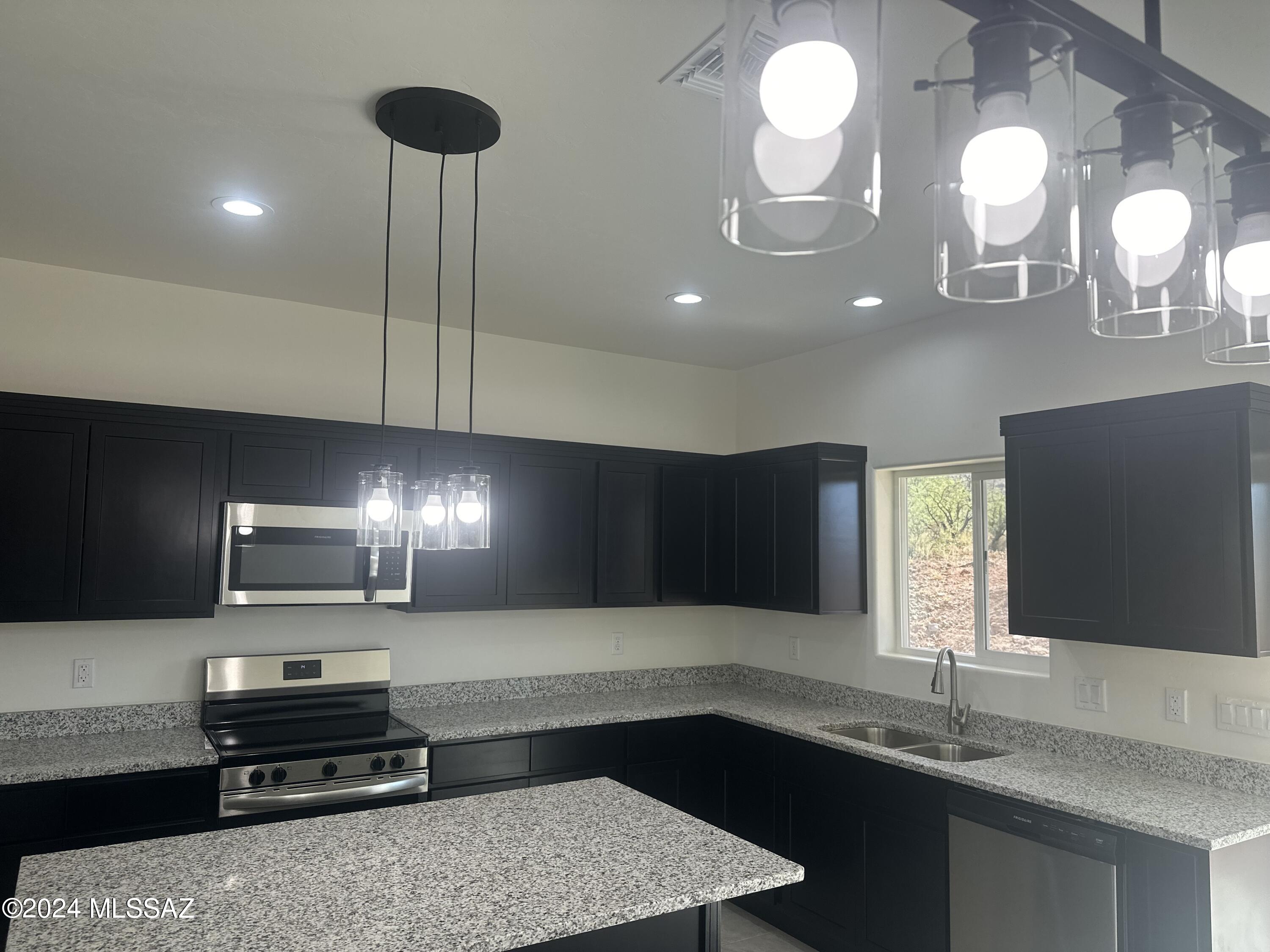 169 Camino Mar Rio Rico, AZ 85648 - Photo 10 of 40 a kitchen with cabinets and chandelier