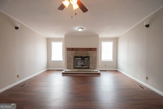 a living room with hard wood floors and a fireplace