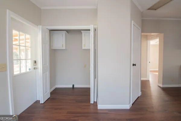 a view of a hallway with wooden floor