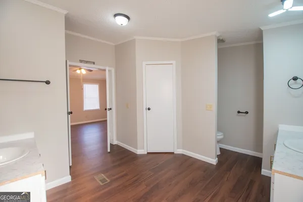 a view of a hallway with wooden floor