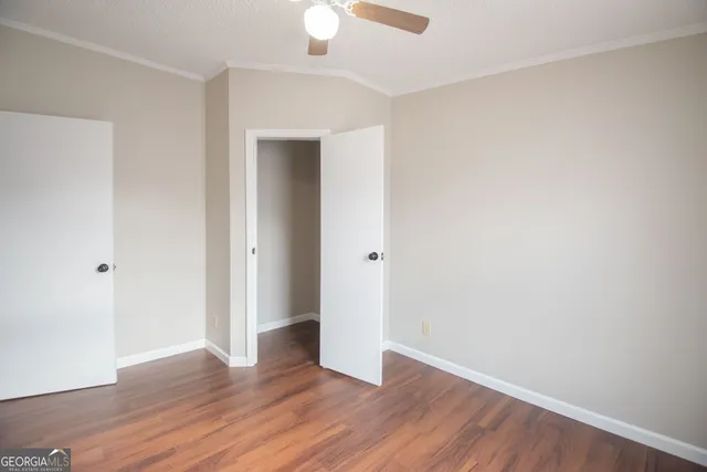 a view of an empty room with wooden floor