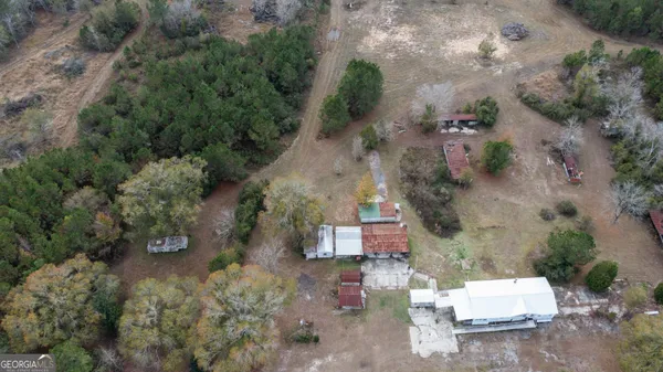 an aerial view of a house with a yard
