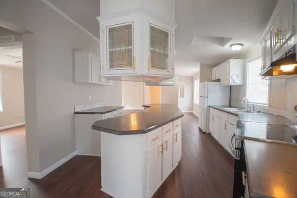 a kitchen with stainless steel appliances granite countertop a sink stove and cabinets